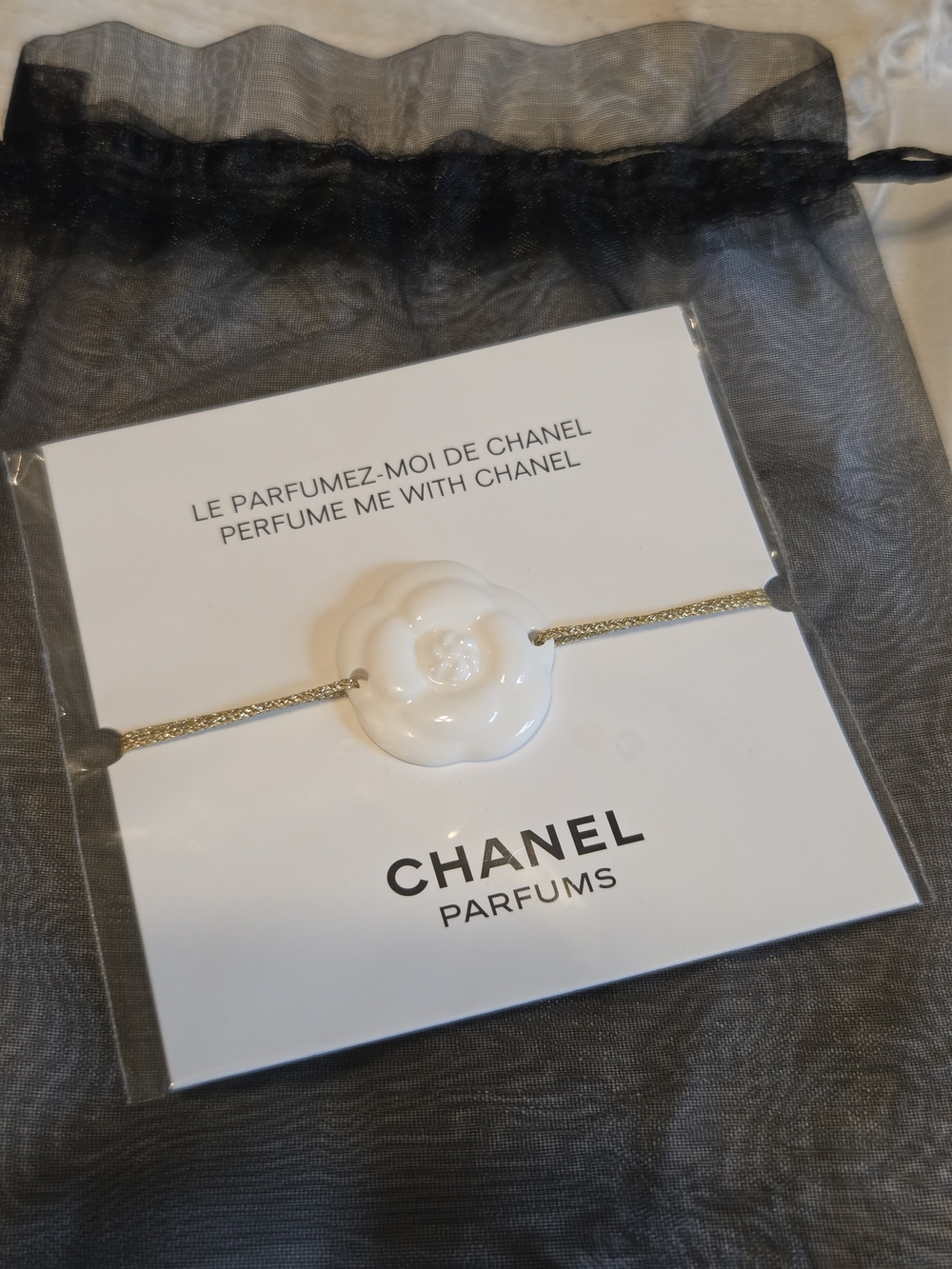 CHANEL Gold-Tone Cord Bracelet with White Camellia Charm